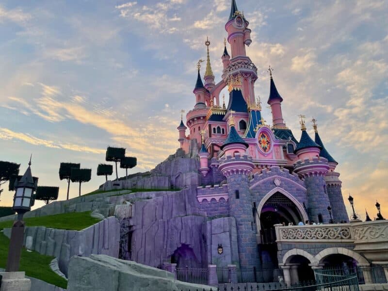 Beautiful Disneyland Paris castle in pinks and purples at sunset