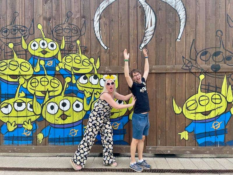 Blonde woman in sunglasses and flowery jumpsuit pose