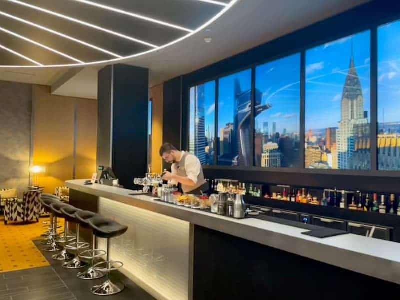Bartender preparing a cocktail at the Skyline Bar Disneys Art of Marvel Hotel