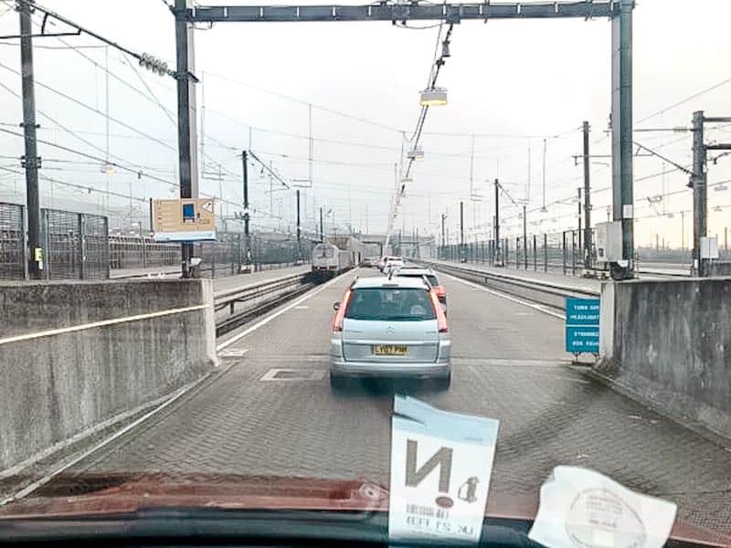 The view from a car as it is queuing to board Le Shuttle Eurotunnel, one the cheapest ways to get to Disneyland Paris. A silver car is in front on a grey day