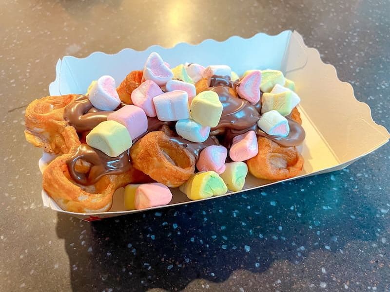 A fun treat at Disneyland Paris for teenagers is this Mickey waffle sundae, covered in colourful mini marshmallows and chocolate sauce