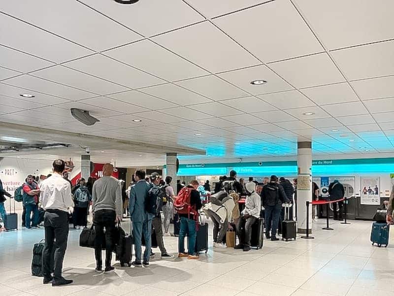 A busy ticket hall for RER trains at Gare du Nord. Customers are queing up to buy their train tickets