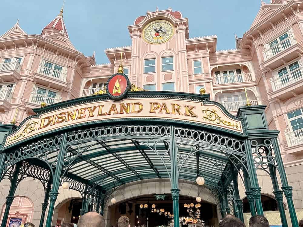 Buy your Disneyland Paris annual pass at the main park, this is the pink hotel entrance with a gold sign saying Disneyland Park