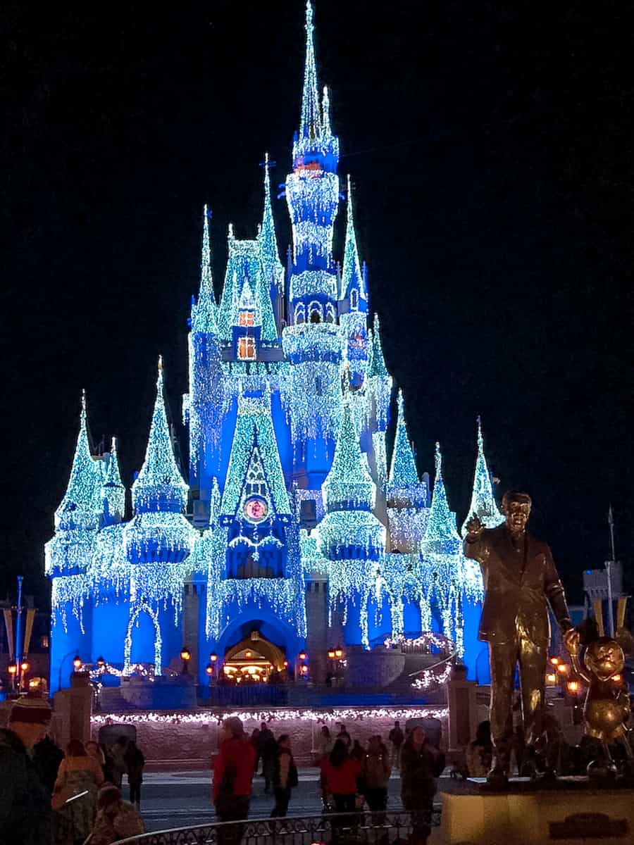 Cinderella Castle in Magic Kingdom, Walt Disney World, lit in sparkling blue lights for the Christmas season