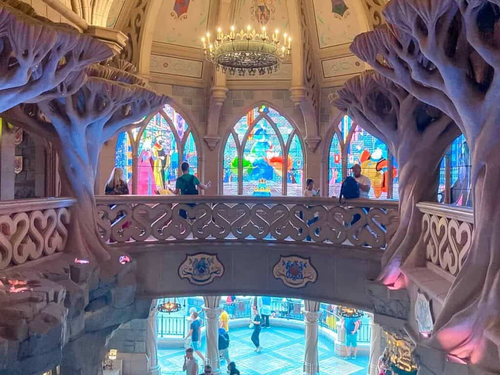 Beautiful interior of Sleeping Beauty Castle - glass windows, chandeliers and tree sculptures decorate the upper level
