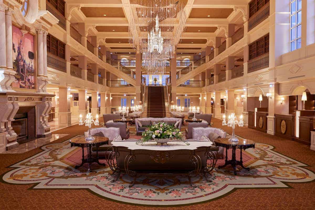 Luxurious Disneyland Hotel Lobby with chandeliers and thick carpets, one of the Disneyland Paris extras guests can choose from