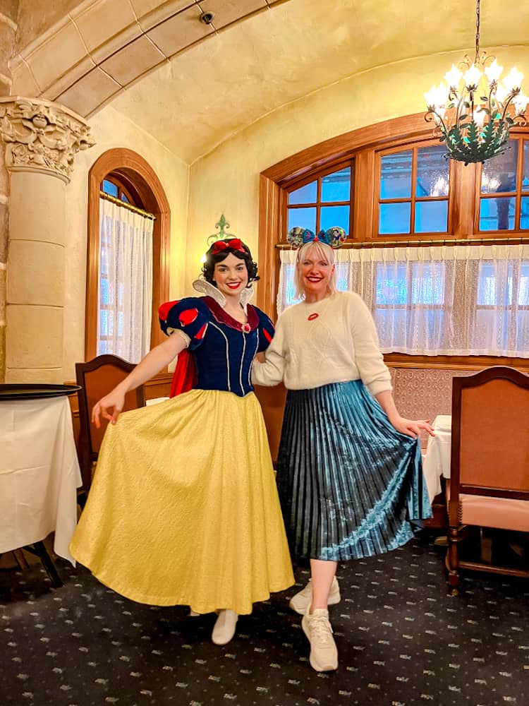 A joyful pose with Snow White and Disneyland Paris blogger Carrie-Anne Hall showing off twirl-worthy skirts at Auberge de Cendrillon.