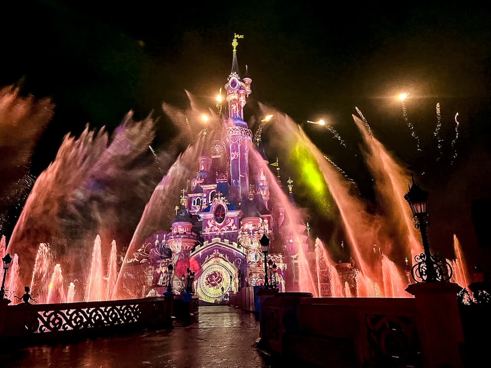 Close-up view of the castle and water effects from the exclusive Tales of Magic Reserved Access viewing area at Disneyland Paris.