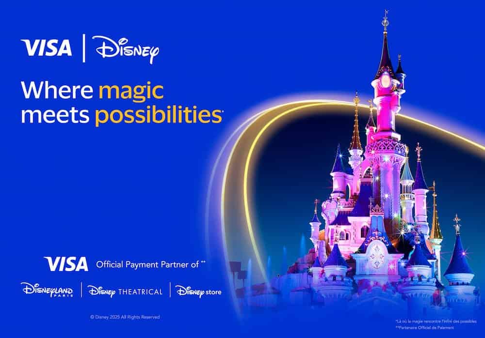Disneyland Paris castle glowing at night with Visa branding, promoting the Disneyland Paris Visa Perk as part of the new partnership.
