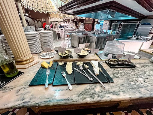 Cheese station at Plaza Gardens Disneyland Paris, offering a selection of French cheeses and accompaniments