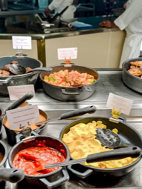Plaza Gardens buffet selection featuring pasta, tomato sauce, and meat dishes for a variety of dining options.