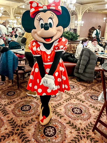 Minnie Mouse posing for photos at Plaza Gardens Disneyland Paris during the character dining experience