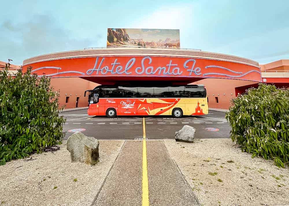 The entrance of Hotel Santa Fe at Disneyland Paris with a Magic Shuttle parked in front, ideal for guests looking into Hotel Breakfasts at Disneyland Paris prices