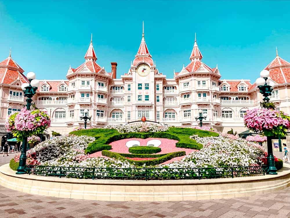 The Disneyland Paris hotel entrance with a Mickey Mouse flower bed, perfect for last-minute travellers arriving at the park.