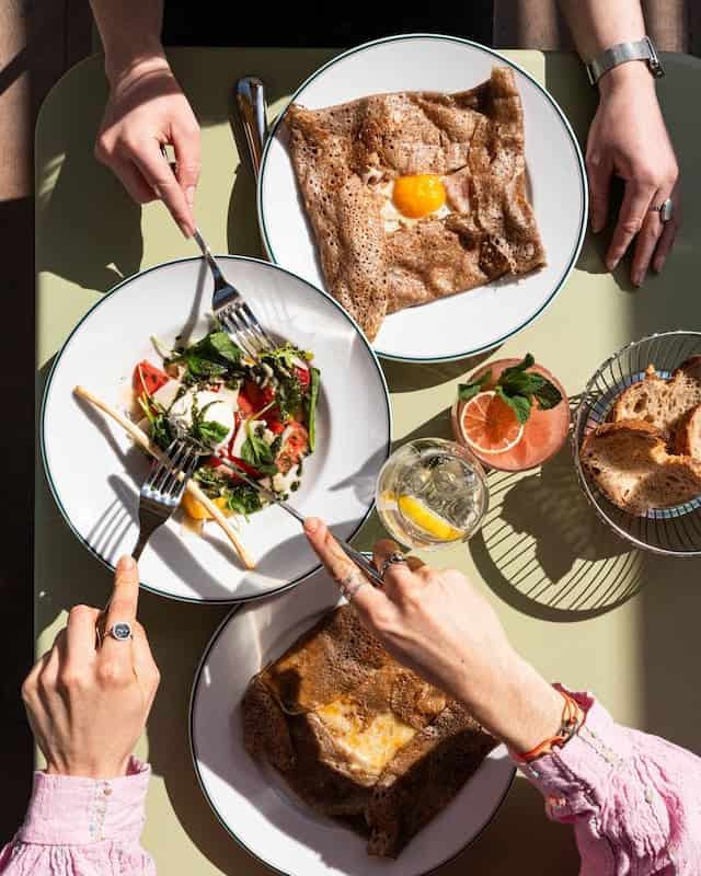 A fresh lunch spread at Petite Rosalie Terrace featuring galettes, salad, and lemonade at Disneyland Paris