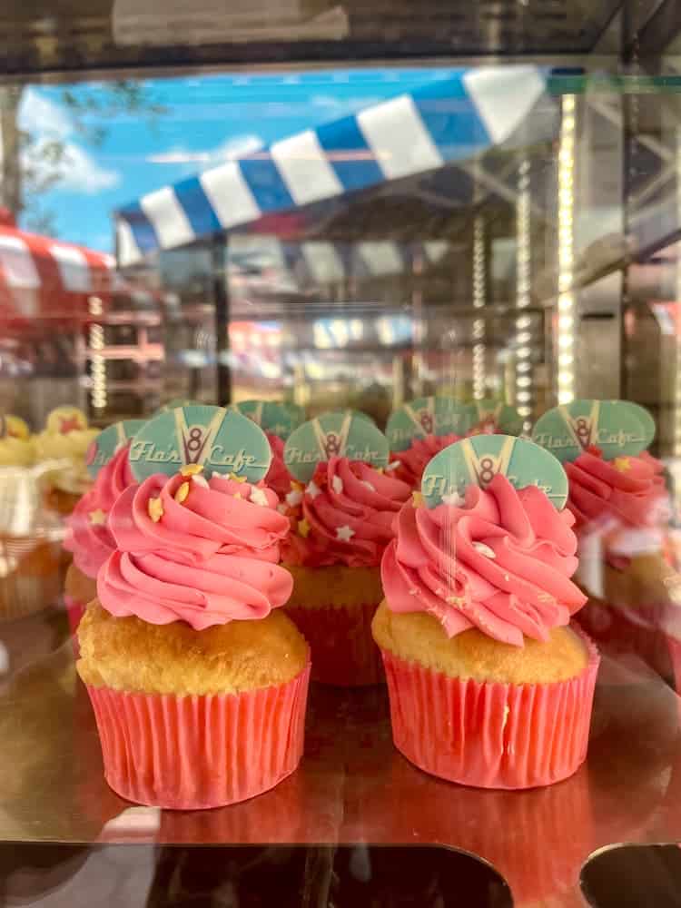 Pink frosted cupcakes from Flo’s V8 Café on display at Disneyland Paris in June, perfect for a summery park treat