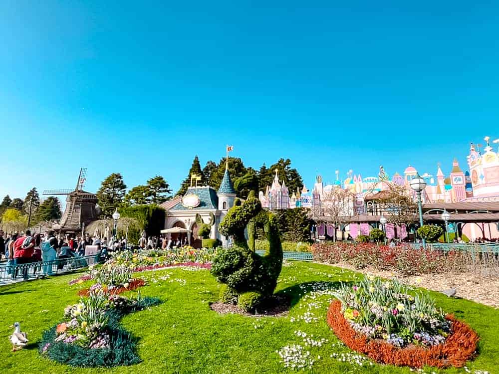 Topiary kangaroo surrounded by colourful flower beds near It’s a Small World at Disneyland Paris in May.