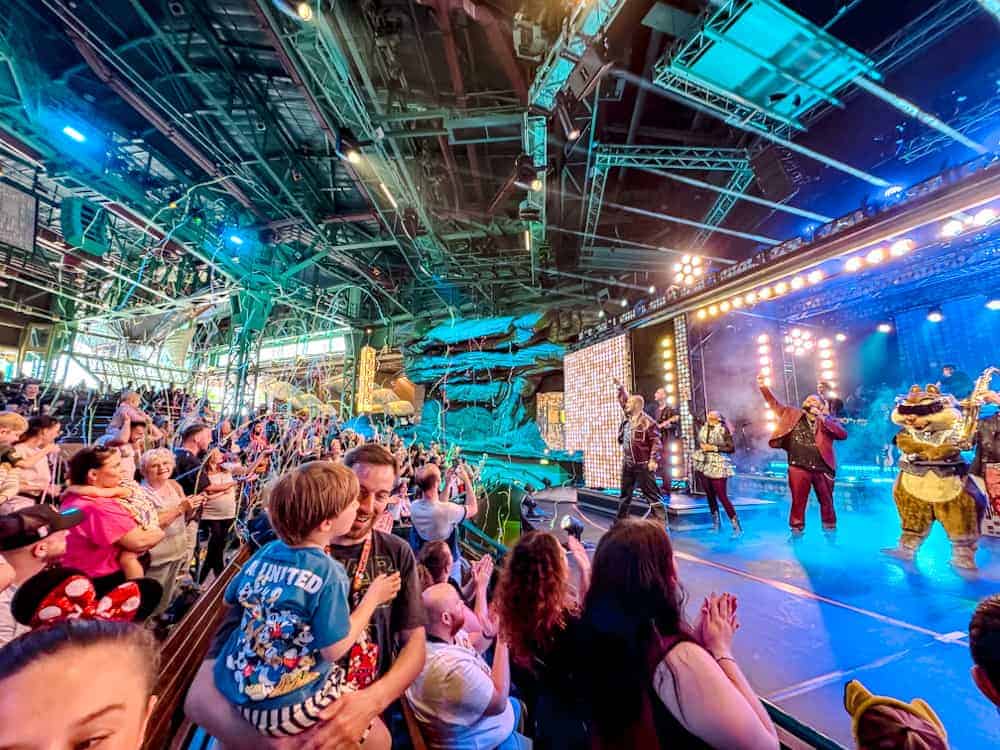 Guests cheer and streamers fly during the Disney Music Festival Hits Show at Videopolis. One of the biggest indoor performances of the event.