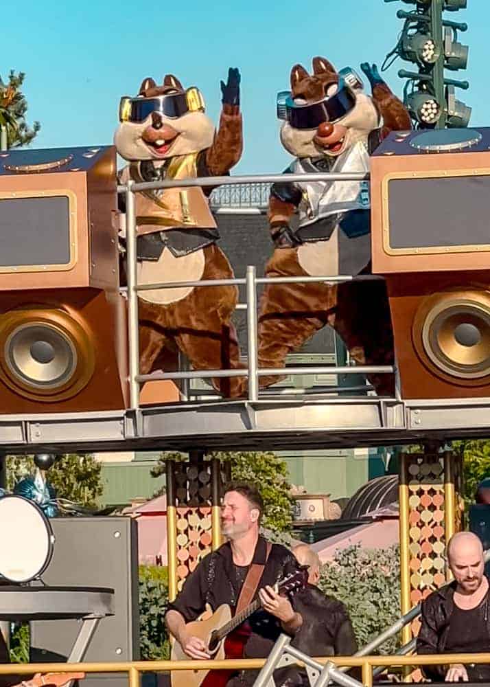 Chip and Dale wear futuristic DJ outfits as they perform atop a music float during the Disney Music Festival. A high-energy highlight of the finale parade.