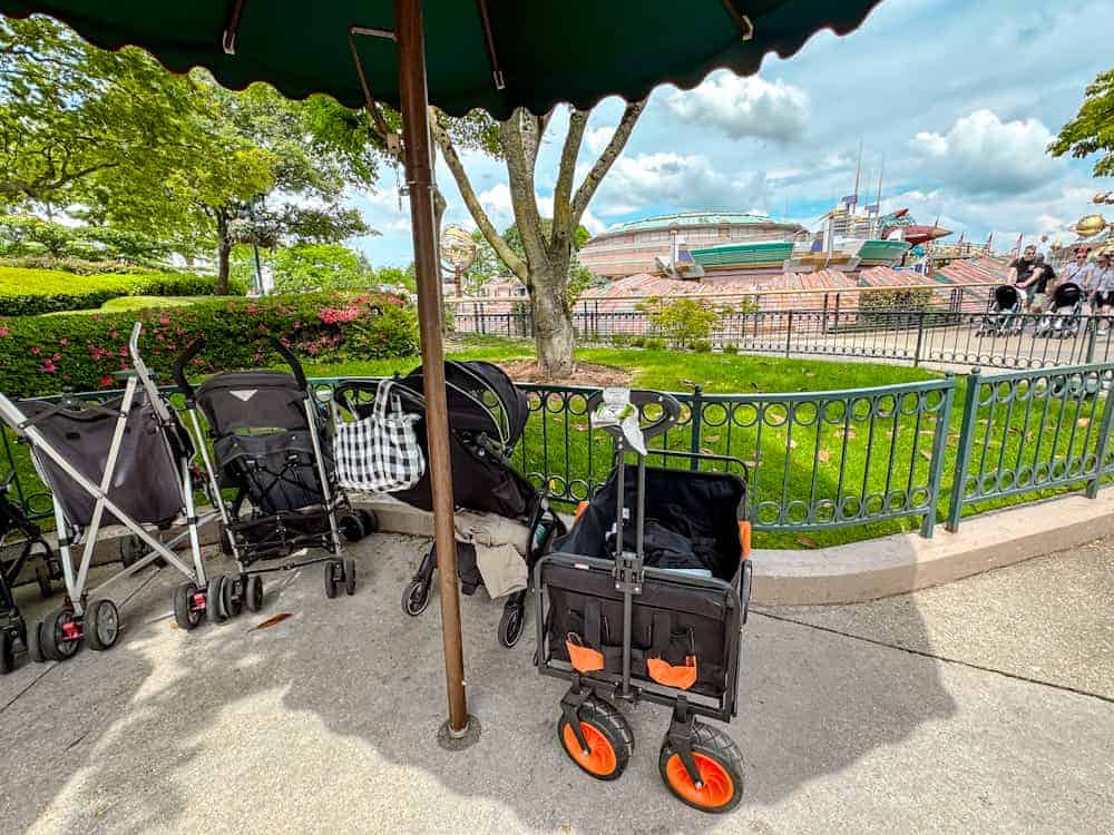 Pushchairs and a wagon parked in Disneyland Paris, with Space Mountain visible in the background.