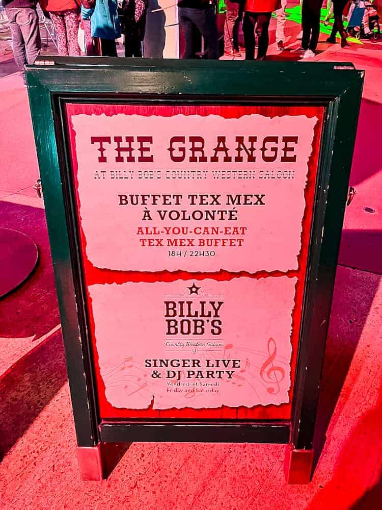 Sign outside The Grange at Billy Bob’s Saloon advertising the Tex-Mex buffet and weekend live music and DJ nights at Disneyland Paris.
