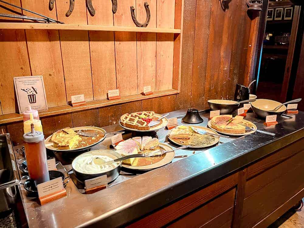 Rows of desserts including chhesecake, red velvet cake, lemon meringue and more on the buffet at Billy Bob’s in Disneyland Paris.