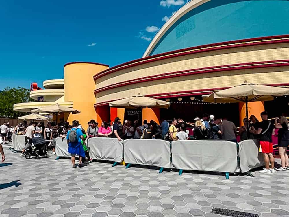 Busy lunchtime queue at Walt Disney Studios Park on a sunny July afternoon at Disneyland Paris.