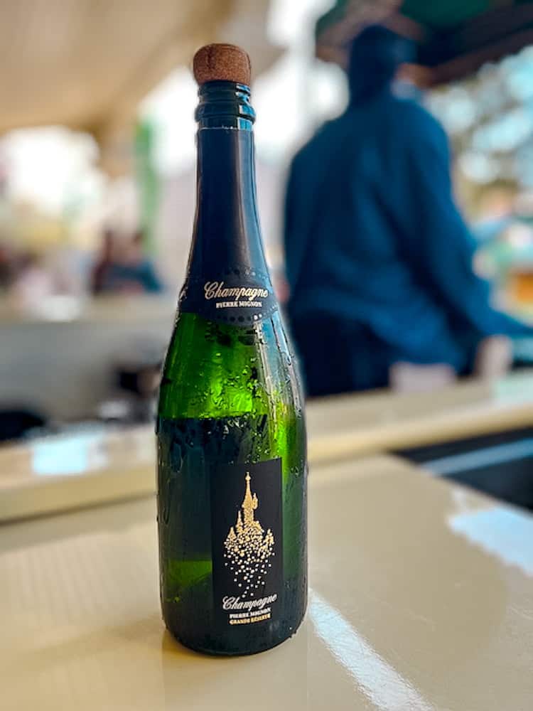 Chilled bottle of Disneyland Paris champagne, perfect for toasting a hot summer day in July.