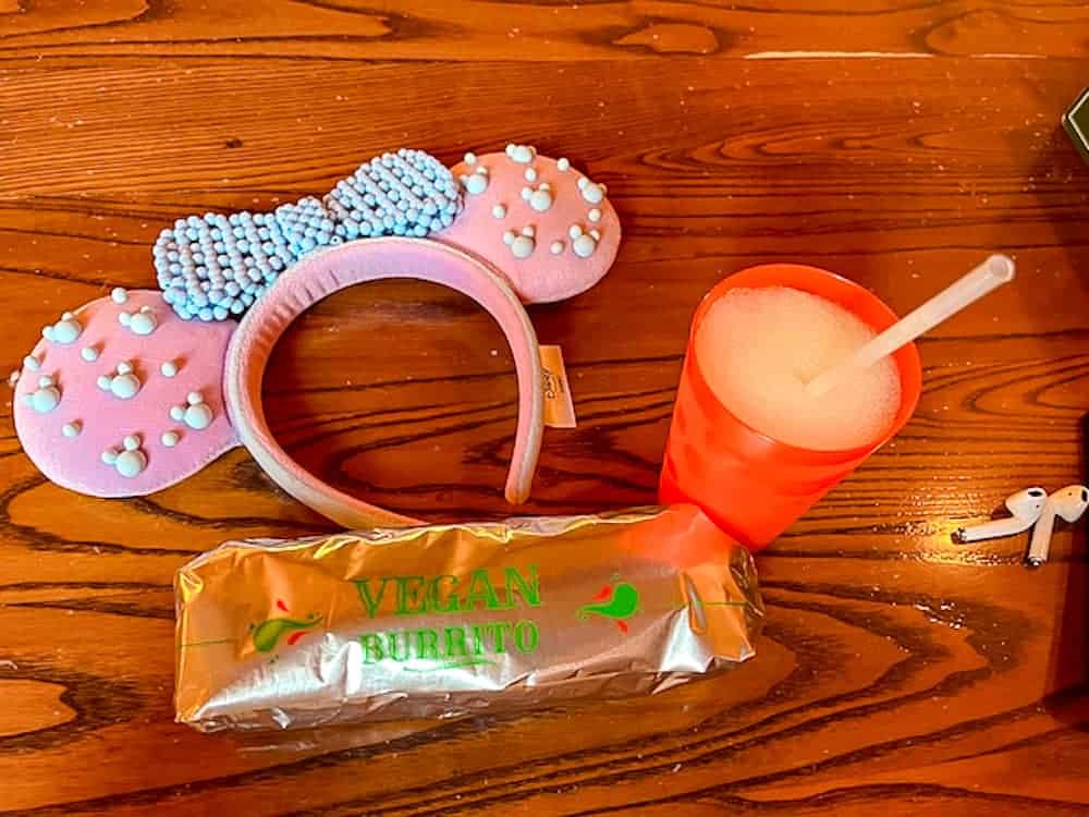 Vegan burrito and frozen maragarita slush drink at Casa de Coco in July at Disneyland Paris. Shown with cute purple and blue Minnie ears during a summer visit.