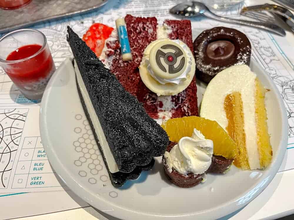 Assorted desserts from Pym Kitchen buffet at Disneyland Paris, including themed red velvet cake and chocolate mousse – a treat for sweet lovers.