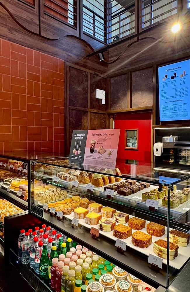 A display of pastries, cakes, and bottled drinks inside the Starbucks Disney Hotel Cheyenne café area.
