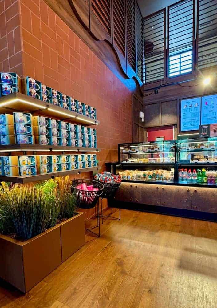 Colourful Disney mugs and cosy wooden décor inside the renovated Starbucks at Disney Hotel Cheyenne.