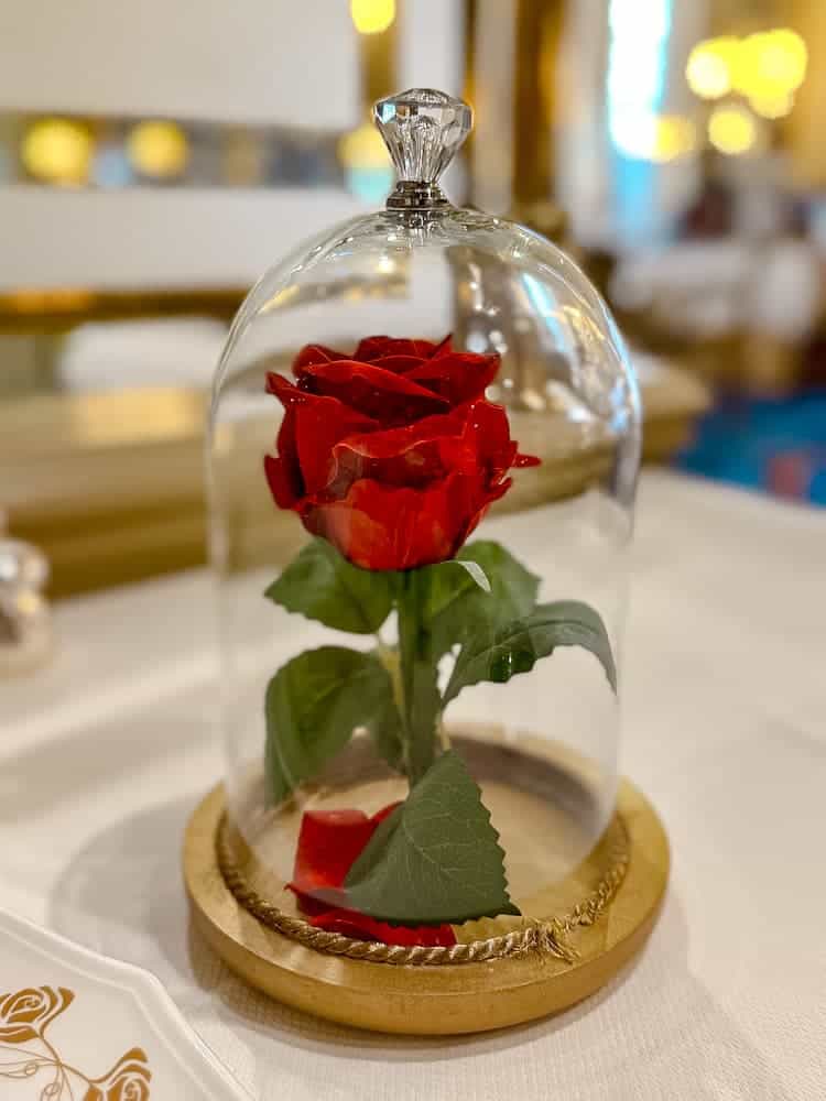 The signature enchanted rose in a glass dome at La Table de Lumière, Disneyland Paris, inspired by Beauty and the Beast.