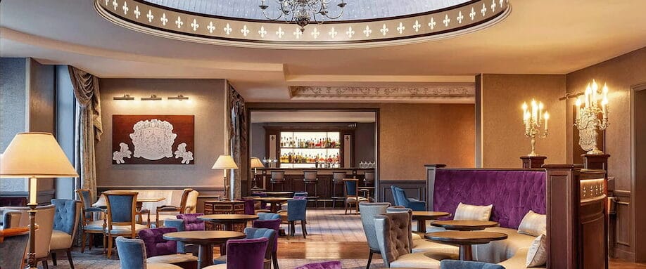 Elegant interior of the Fleur de Lys Bar at Disneyland Paris, featuring plush velvet seating, chandeliers, and a refined royal-themed design inside the Disneyland Hotel.