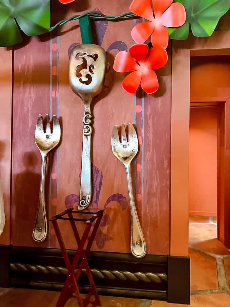 Oversized fork and spoon wall décor with flowers at Bistrot Chez Rémy Disneyland Paris