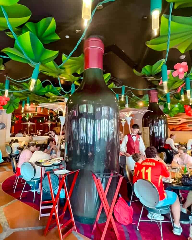 Giant wine bottle decoration inside Bistrot Chez Rémy at Disneyland Paris