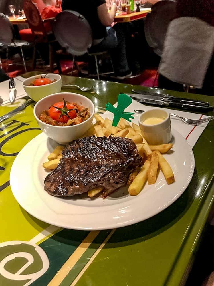 Grilled steak with fries, ratatouille, and peppercorn sauce at Bistrot Chez Rémy Disneyland Paris