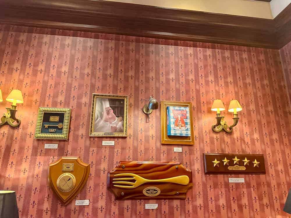 Awards wall with Chef Gusteau’s cookbook and plaques at Bistrot Chez Rémy Disneyland Paris