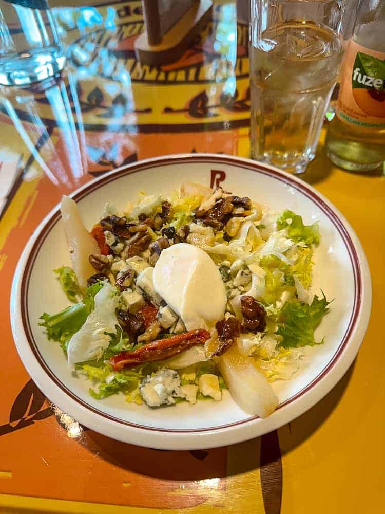 Mixed greens salad with roquefort, pear, walnuts, and poached egg at Bistrot Chez Rémy Disneyland Paris