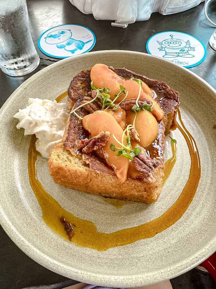 Grown-up French toast with caramelised peaches and orange bourbon glaze at Lamplight Lounge, Pixar Pier — a unique Disneyland California dining option.