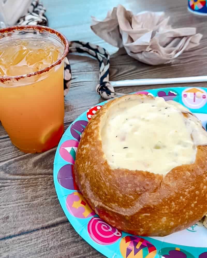 Creamy clam chowder served in a sourdough bread bowl at Harbour Galley, Disneyland California — one of the best Disney food choices for lunch.