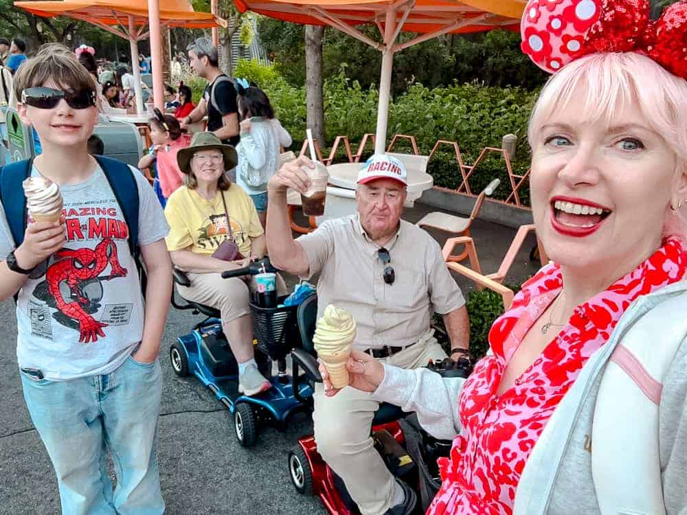 Carrie-Anne with her son, dad, and stepmum enjoying ice-cream cones at Disneyland California, introducing her Disneyland California vs Disneyland Paris trip report