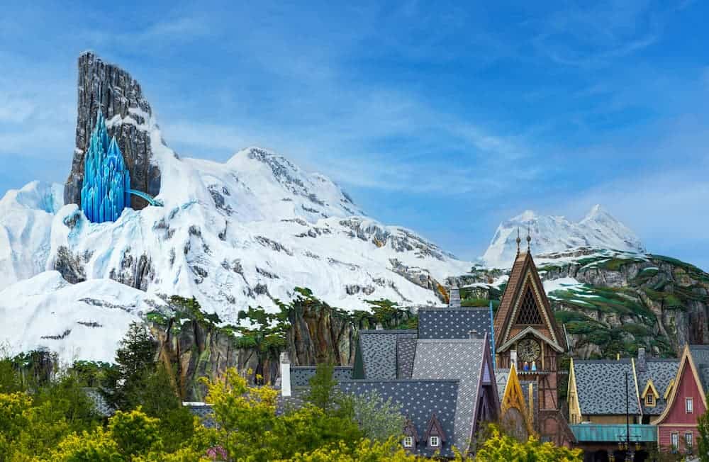 Concept art of World of Frozen Disneyland Paris showing Elsa’s Ice Palace on the North Mountain and the village of Arendelle.