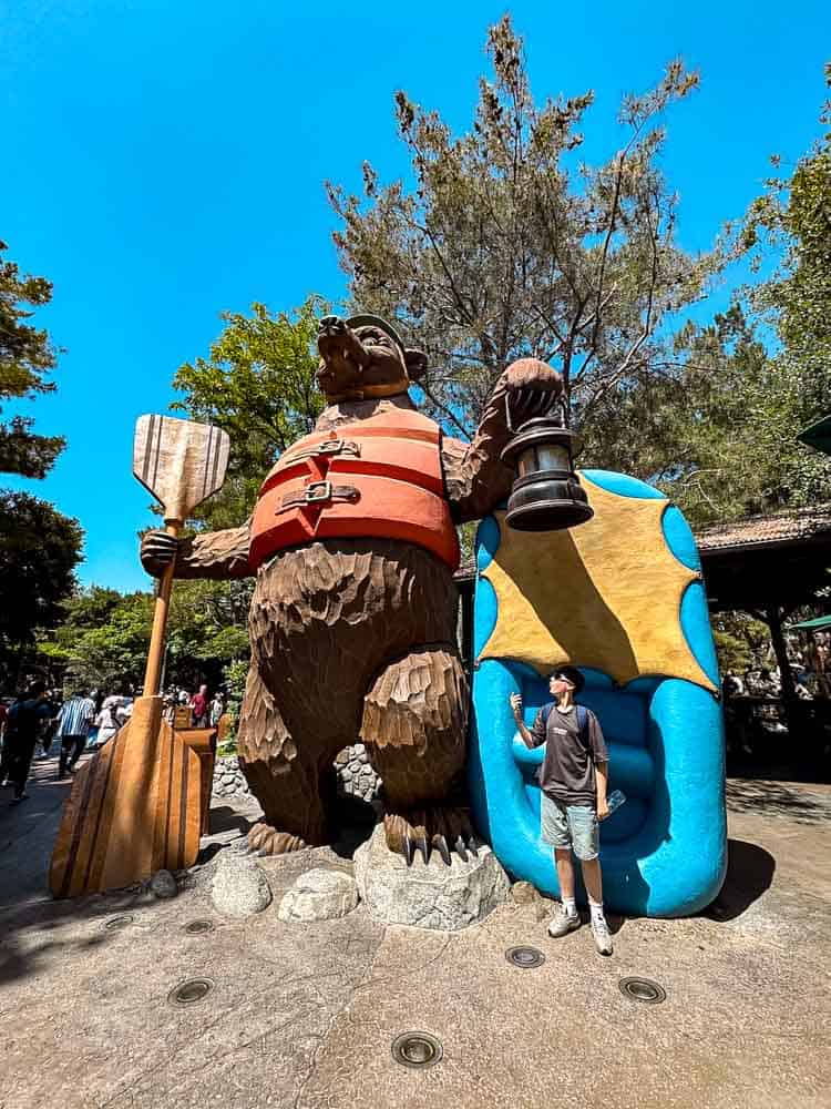 Jackson posing by the giant bear statue at Grizzly Peak in Disney California Adventure during Carrie-Anne’s 3-Day Disneyland California Itinerary.
