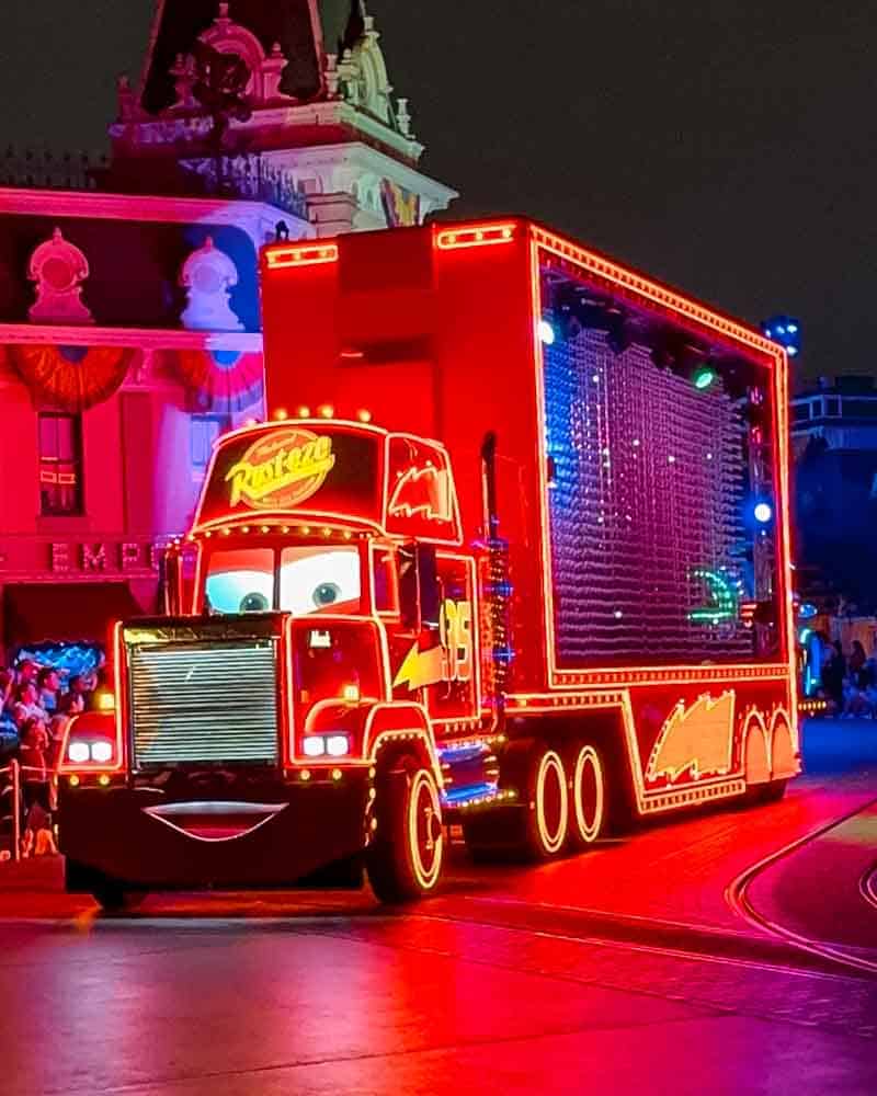 Mack Truck glowing in neon lights during Disneyland’s nighttime parade, a highlight of our 3-Day Disneyland California Itinerary.