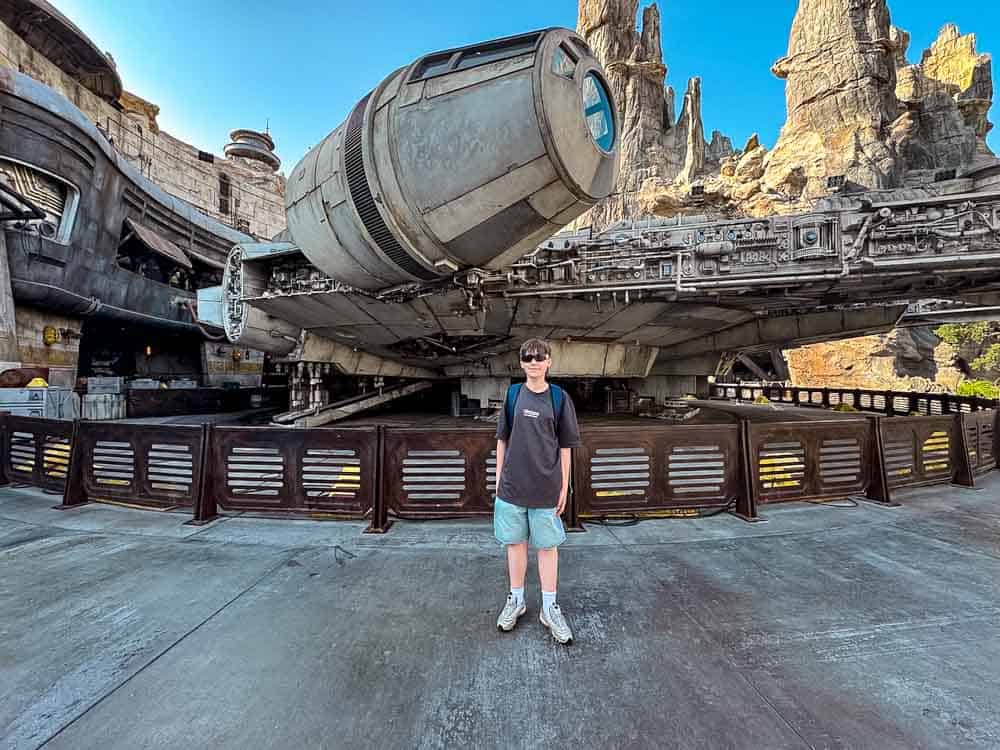 Jackson standing in front of the Millennium Falcon at Galaxy’s Edge, a Star Wars highlight of Carrie-Anne’s 3-Day Disneyland California Itinerary.