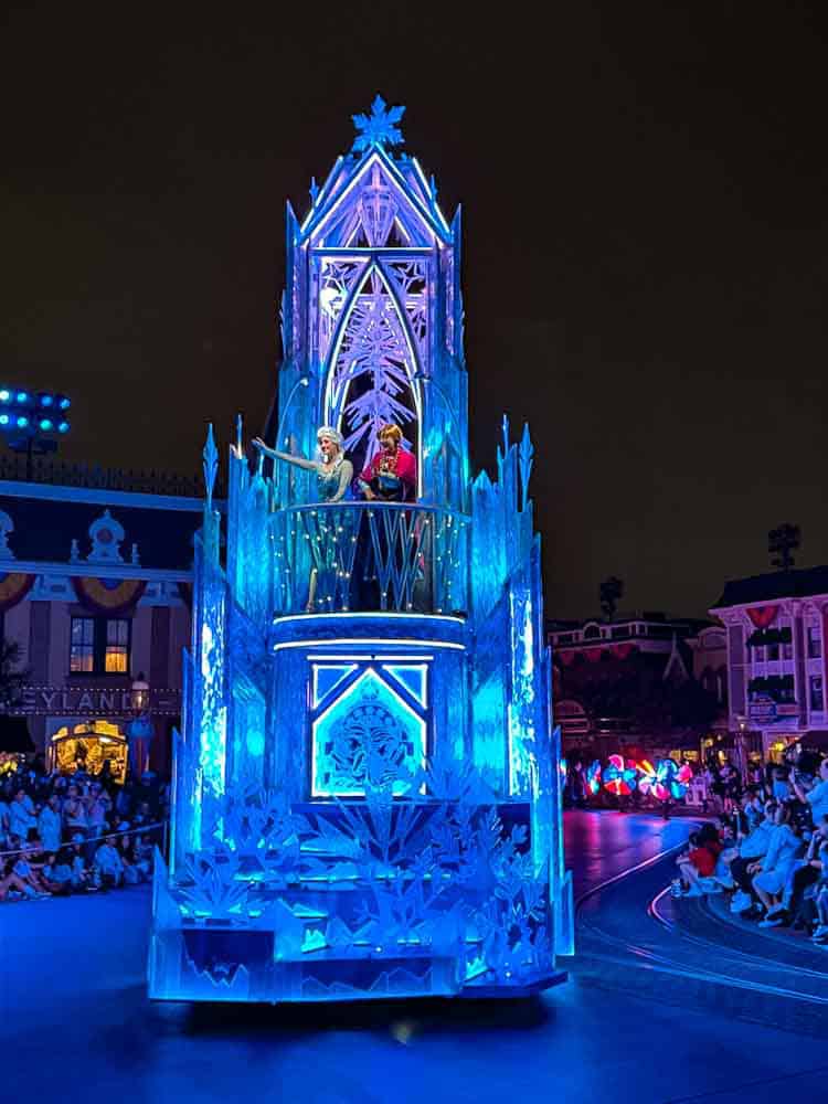 Frozen-themed float with Elsa and Anna in the Disneyland night parade on a 3-Day Disneyland California Itinerary.