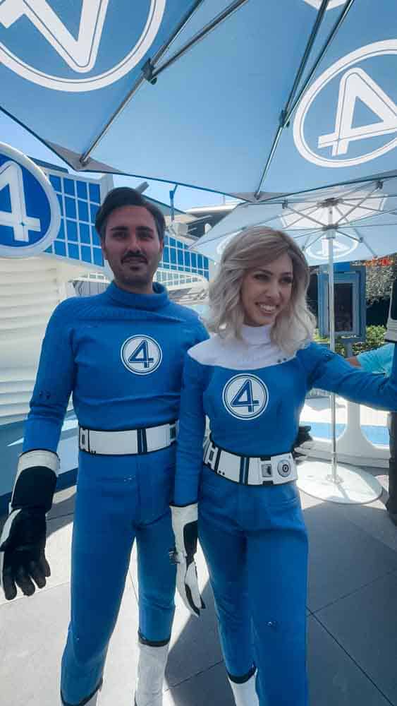 Disney performers dressed as Mr. Fantastic and Invisible Woman greeting guests in Tomorrowland at Disneyland California.