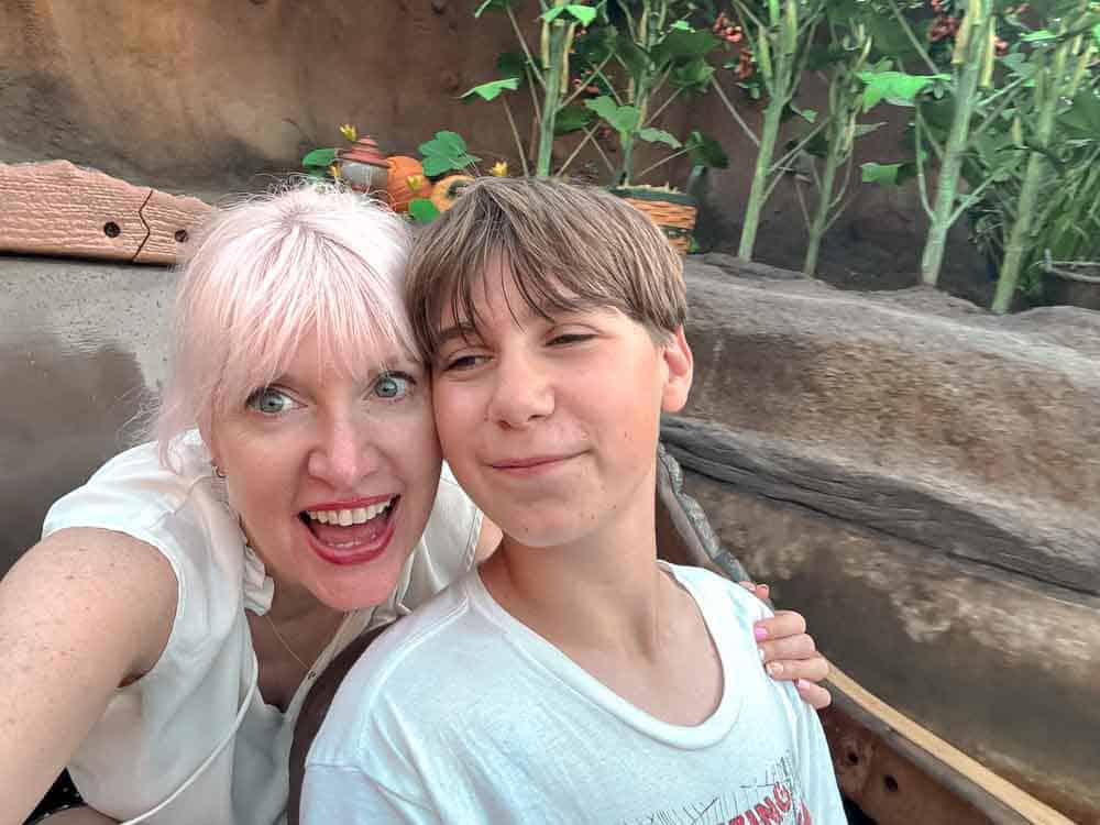 Happy mum and son taking a selfie on a log ride Tiana's Bayou Adventure at Disneyland California, enjoying the fun before the big drop.