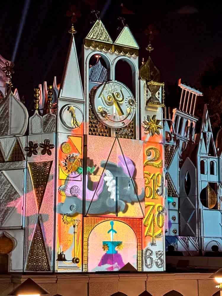 The façade of it’s a small world lit with colourful evening projections, seen during our 3-Day Disneyland California Itinerary.